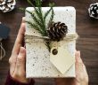 Photo of hands holding a wrapped Christmas gift