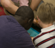 Adult with their arm around a child during a children's ministry