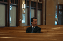 Person sitting alone in the pews