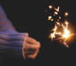 Person holding a sparkler in the darkness