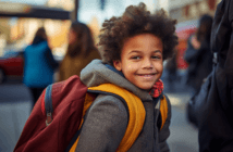 Happy child wearing a backpack from a church school supply donation drive