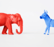 Red elephant and blue donkey facing each other