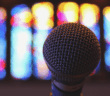 Microphone in front of stained glass windows