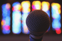 Microphone in front of stained glass windows