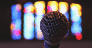 Microphone in front of stained glass windows