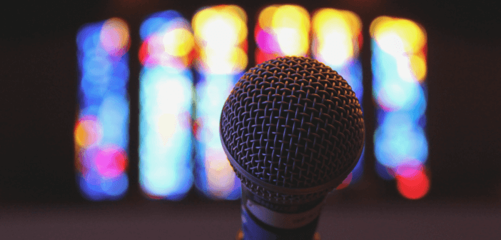 Microphone in front of stained glass windows