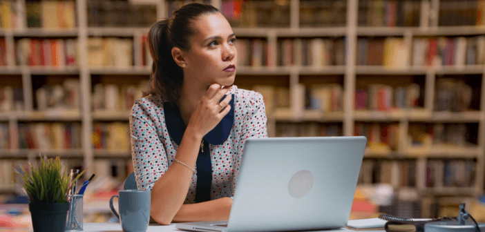 Pastor in front of a computer trying to think of what to write